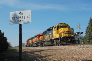 BNSF 8707 leads the Longmont Switch power past another "BN INC" sign at MP 62.
